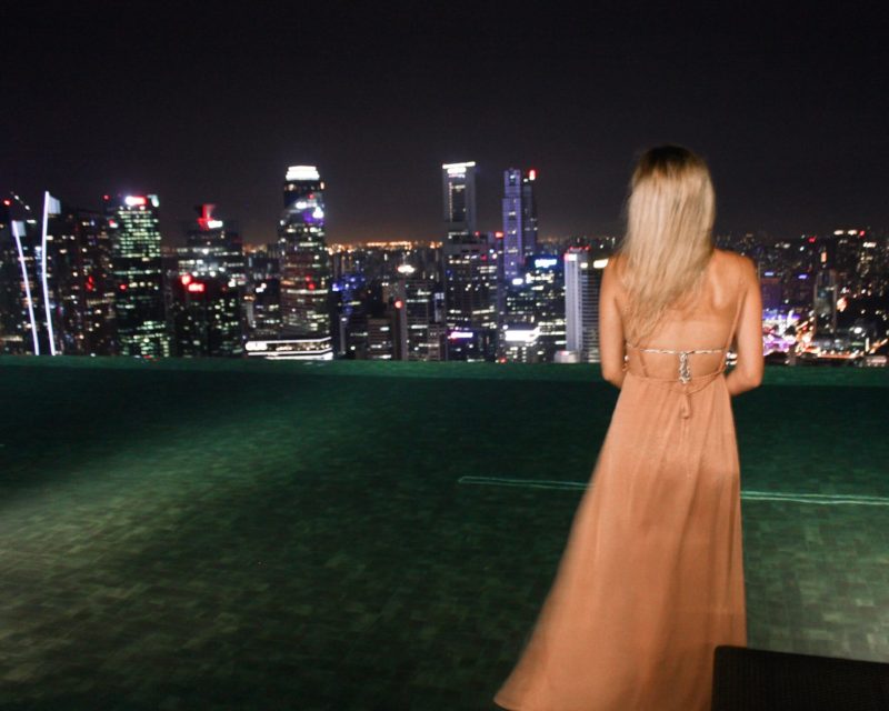 looking at the nighttime view in Singapore from the pool on top of the marina bay sands hotel